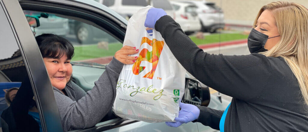 Orange County resident receiving food donation at drive-thru event at Horace Mann Elementary School