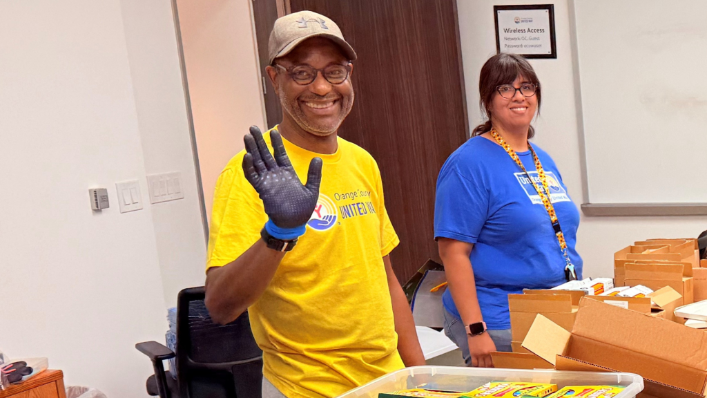 Volunteer Squad member smiling and working at a table indoors.