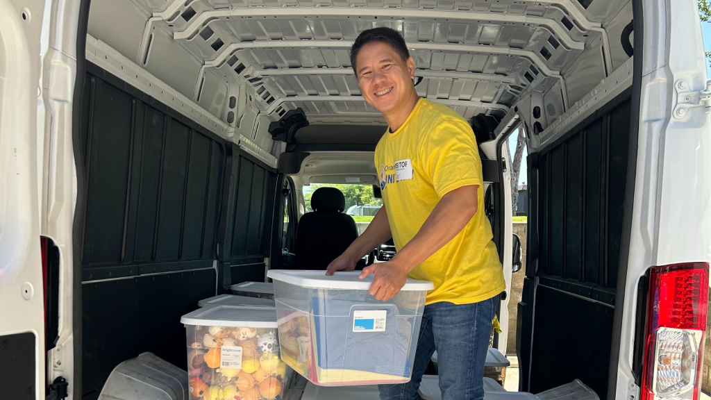 Volunteer Squad member unloading donation bins from a van.